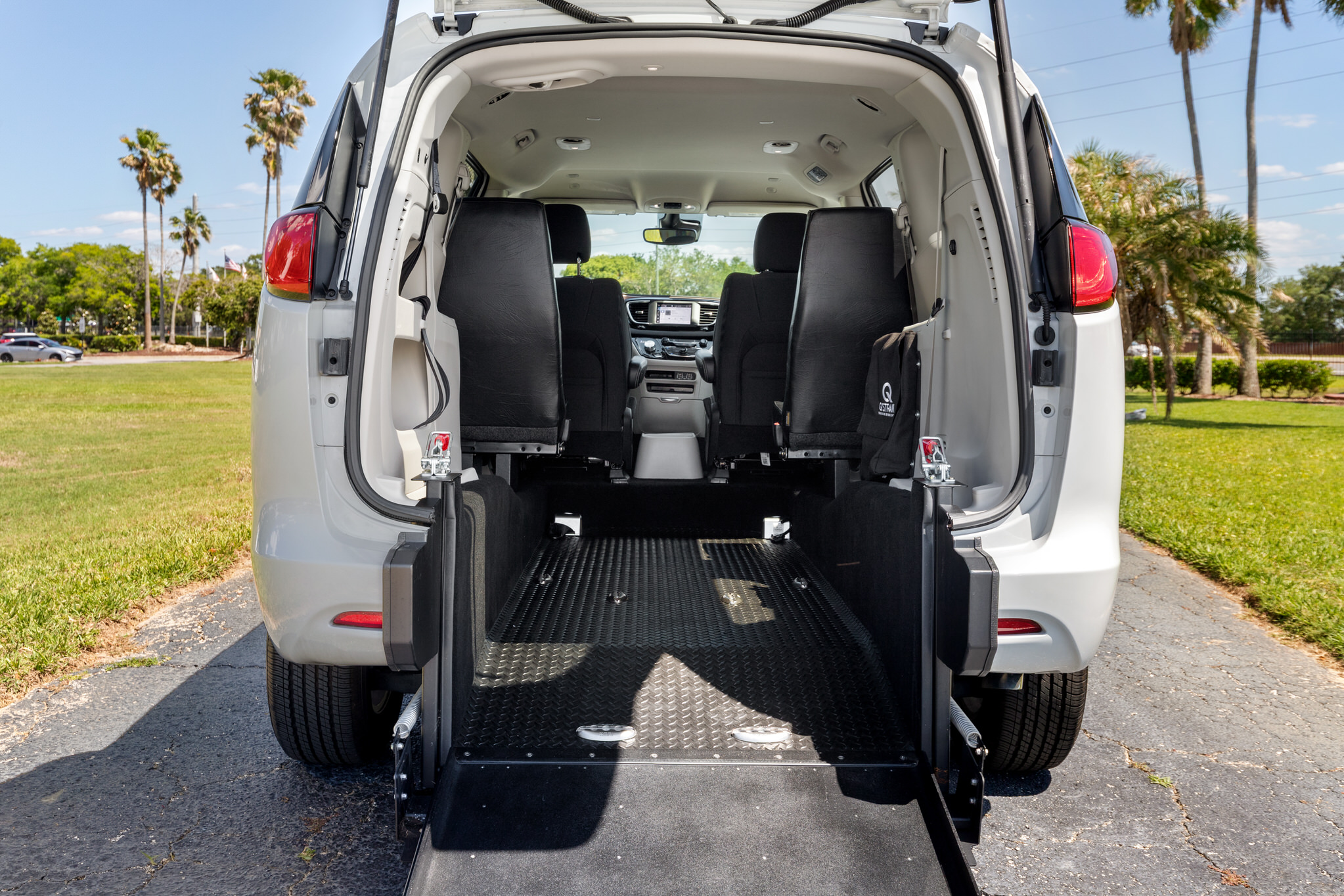Photo of the exterior of a white FR Conversion Van by ABC Companies in Florida. Photo by: Biz360Tours